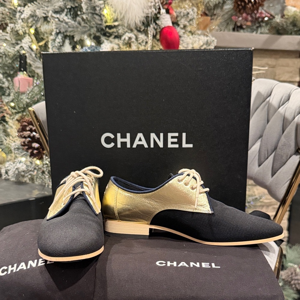 CHANEL Black and Gold Oxfords Shoes.